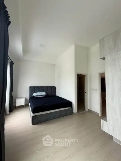 Spacious bedroom with modern design and natural light