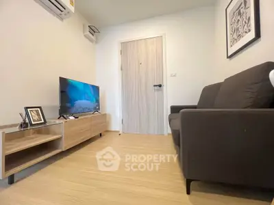 Modern living room with sleek furniture and wall-mounted TV, perfect for cozy relaxation.