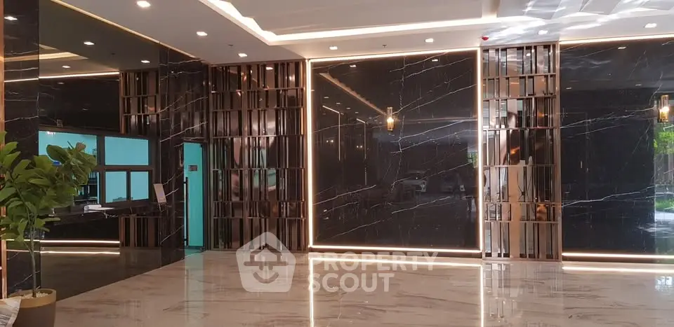 Luxurious modern building lobby with elegant marble flooring and stylish lighting.