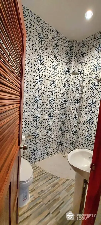 Charming bathroom with unique patterned tiles and modern fixtures, offering a stylish and comfortable space.