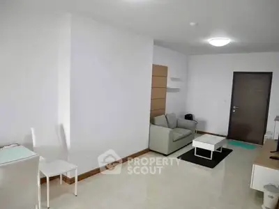 Spacious modern living room with minimalist decor and sleek furniture.