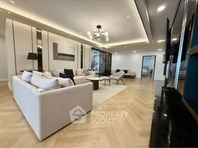Luxurious and spacious living room with elegant decor and modern lighting, perfect for relaxation and entertainment.
