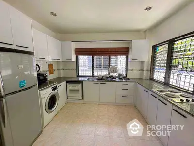 Spacious kitchen with modern appliances and ample storage in a bright, airy setting.