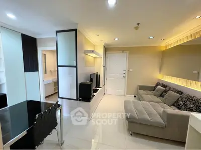 Modern living room with sleek furniture and ambient lighting in a stylish apartment.