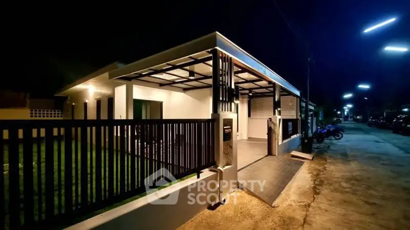 Modern single-story house with sleek exterior design and ambient night lighting