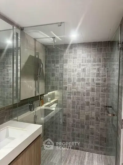 Modern bathroom with glass shower and stylish tile design