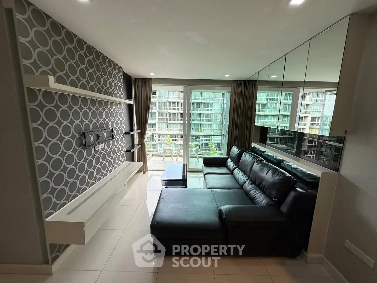 Modern living room with stylish decor and large windows offering a stunning view of the cityscape.