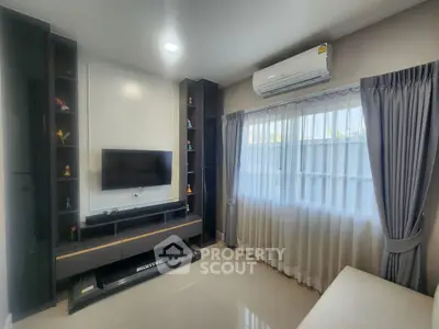Modern living room with sleek TV unit and large window for natural light