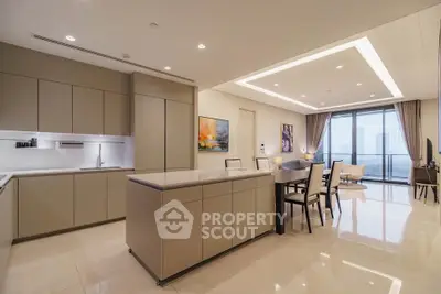 Luxurious open-plan kitchen and dining area with modern design and city view balcony.
