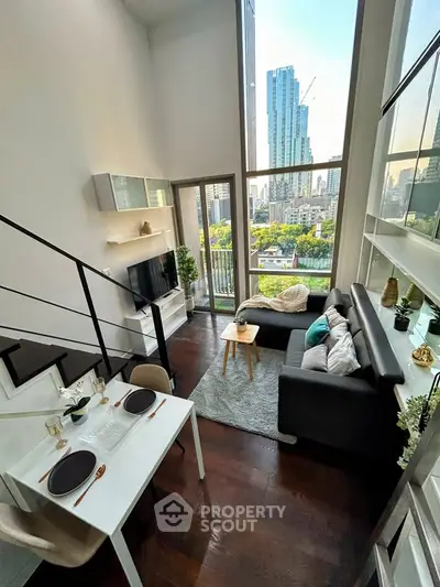 Stunning modern living room with high ceilings and city view, featuring elegant decor and cozy seating area.