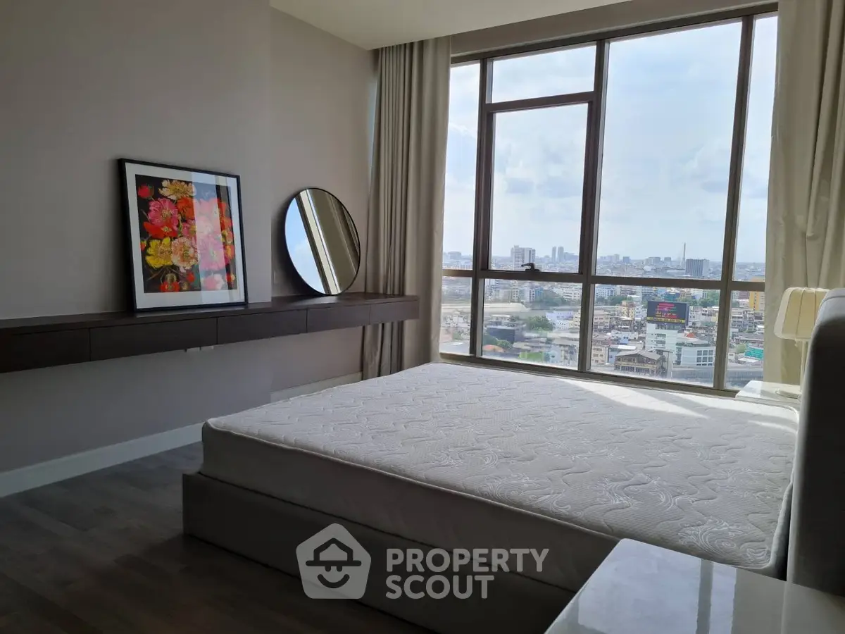 Modern bedroom with large window offering stunning city view, featuring sleek furniture and elegant decor.