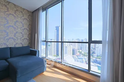 Luxurious high-rise apartment with stunning city view and elegant interior design.