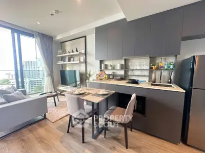 Modern open-layout kitchen and living room with city view, sleek cabinetry, and stylish decor.