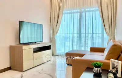 Modern living room with sleek furniture and large windows offering natural light.