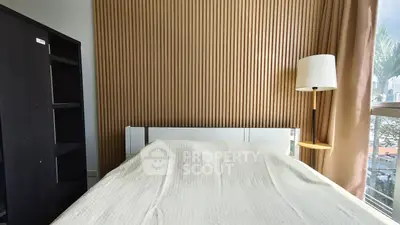 Modern bedroom with stylish wood paneling and natural light