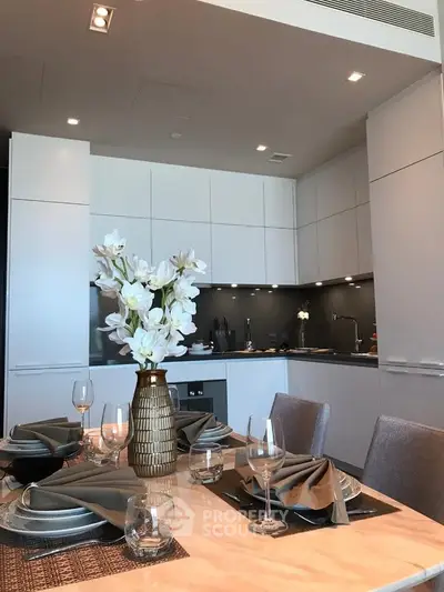 Modern kitchen with elegant dining setup and sleek cabinetry