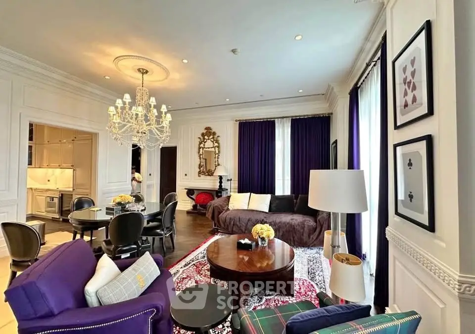 Luxurious living room with elegant chandelier and plush seating in a sophisticated apartment.