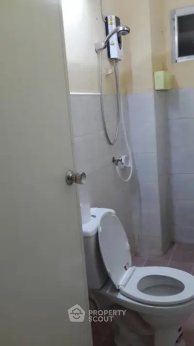 Compact bathroom with shower and toilet in modern apartment