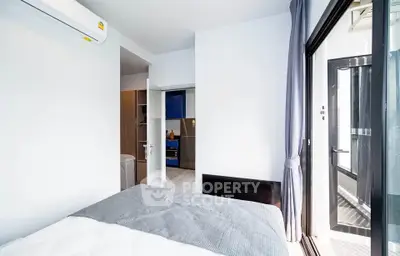 Modern bedroom with balcony access and air conditioning in a stylish apartment