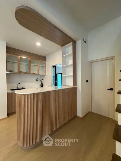 Modern kitchen with sleek wooden cabinetry and open layout design