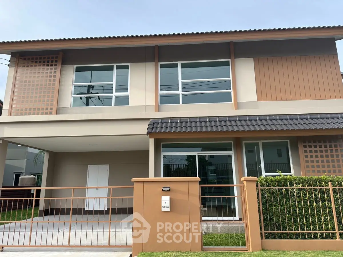 Modern two-story house with a spacious driveway and contemporary design.