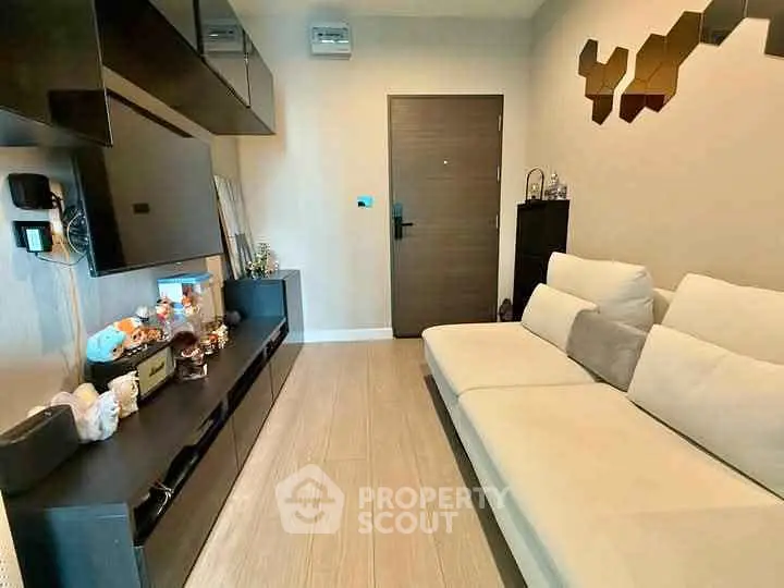 Modern living room with sleek black furniture and cozy white sofa
