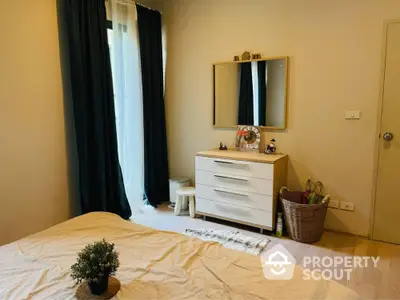 Cozy bedroom with modern dresser and large window for natural light