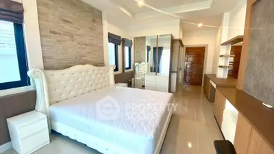Luxurious bedroom with elegant decor and ample natural light