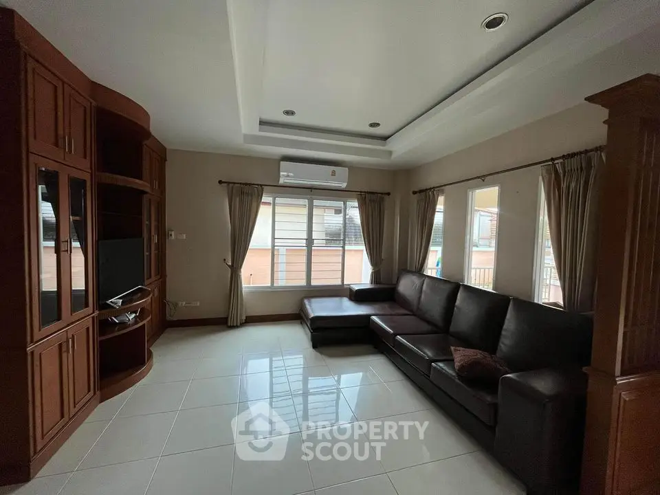 Spacious living room with modern furniture and large windows for natural light