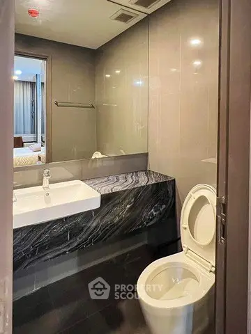 Modern bathroom with sleek design and marble countertop in a stylish apartment.