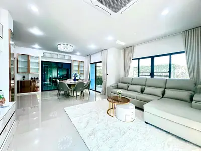 Spacious modern living room with elegant dining area and large windows