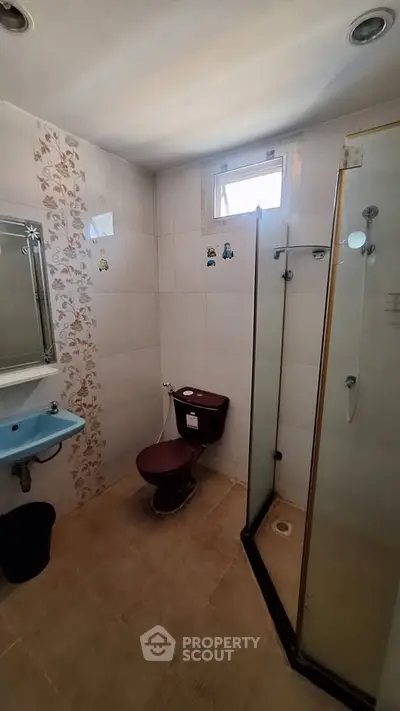 Spacious bathroom with modern shower and unique tile design