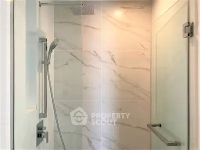 Modern bathroom shower with marble tiles and glass door