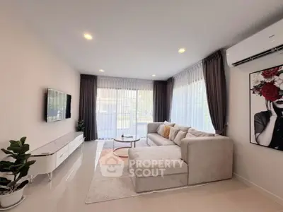 Spacious modern living room with large windows and stylish decor