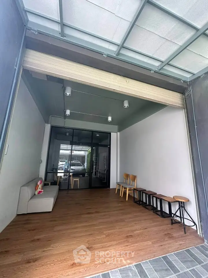 Spacious entrance with wooden flooring and seating area, ideal for welcoming guests.