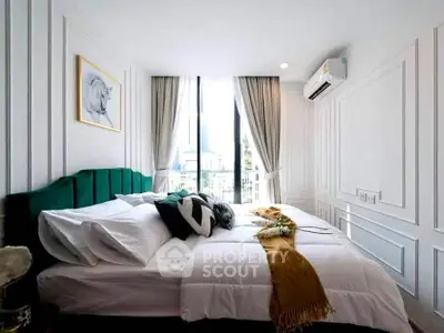 Luxurious bedroom with elegant decor and large window offering city views.