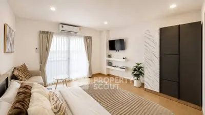 Spacious modern bedroom with elegant decor and natural light