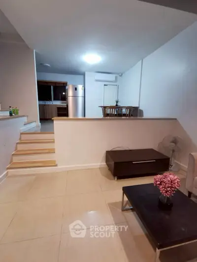 Spacious open-plan living area with modern kitchen and stylish decor