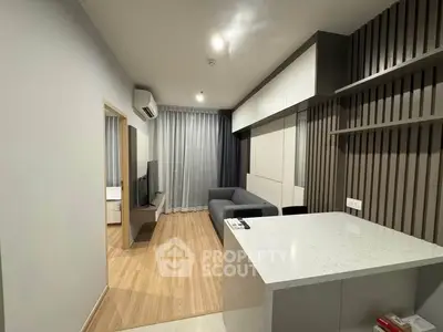 Modern living room with sleek design and open layout, featuring a cozy sofa and stylish decor.