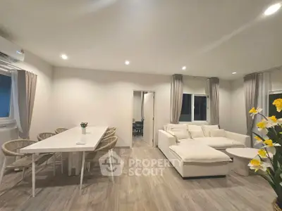 Spacious modern living room with elegant dining area and cozy seating, perfect for family gatherings.