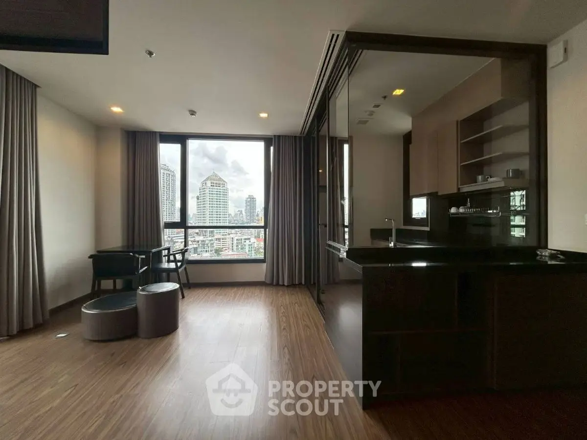 Modern open-layout living room with city view and sleek kitchen design