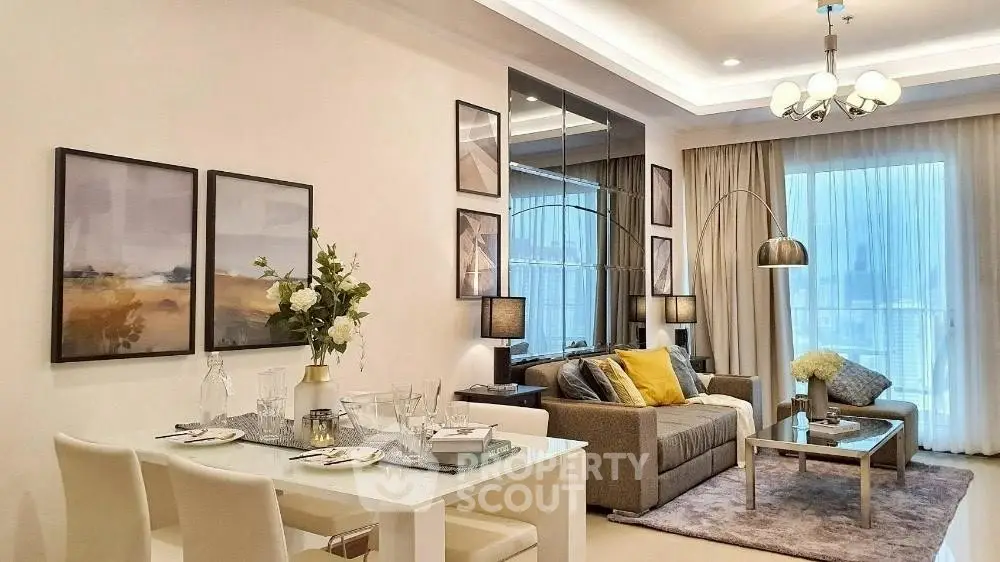 Elegant living room with modern decor and dining area, featuring stylish lighting and cozy ambiance.