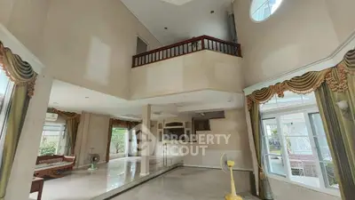 Spacious living room with high ceilings and elegant decor in a luxurious home.