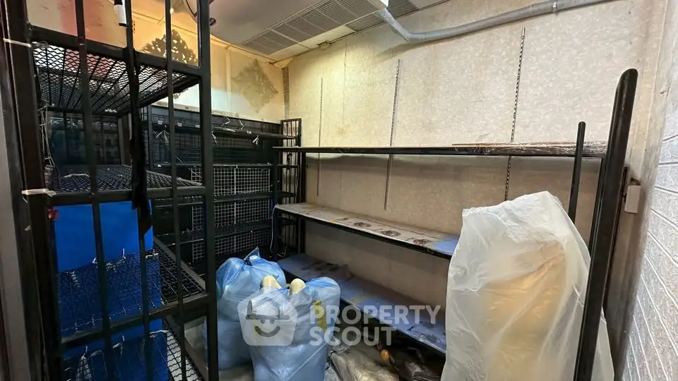 Spacious storage room with metal shelving and organized layout, ideal for efficient space utilization.