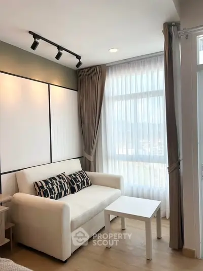 Modern living room with cozy sofa and large window with curtains