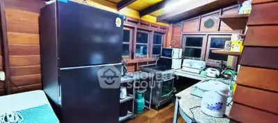 Charming rustic kitchen with modern appliances and wooden interior design.