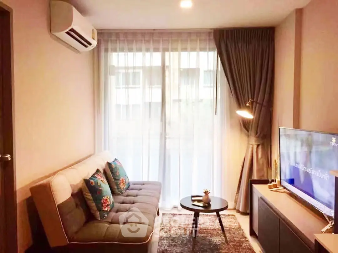 Cozy living room with modern decor and natural light, featuring a comfortable sofa and stylish TV setup.