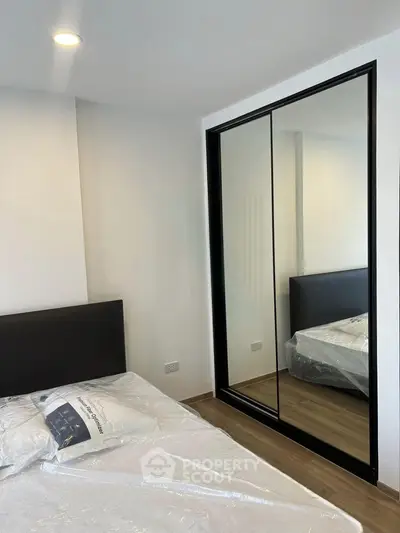 Modern bedroom with mirrored wardrobe and sleek design