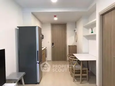 Modern compact kitchen with dining area and sleek appliances