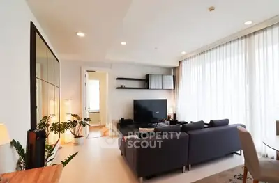 Spacious modern living room with large windows and stylish decor